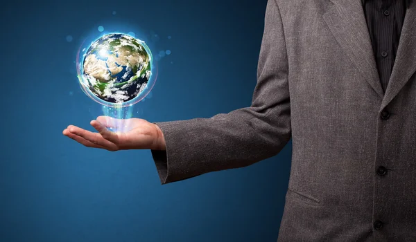 Businessman holding glowing earth globe — Stock Photo, Image