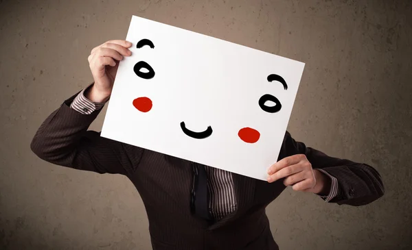Affärsman som håller i en kartong med ett leende ansikte på — Stockfoto