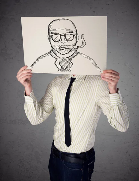 Businessman holding a cardboard with a smoking man on it in fron — Stock Photo, Image