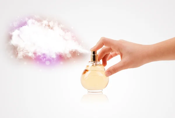 Woman hands spraying colorful cloud — Stock Photo, Image