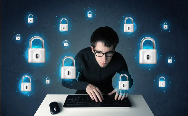 Young hacker with virtual lock symbols and icons — Stock Photo, Image