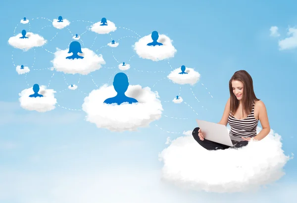 Young woman sitting in cloud with laptop — Stock Photo, Image