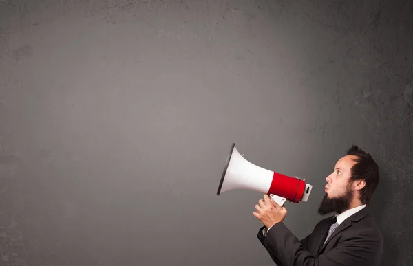 Guy shouting into megaphone on copy space background — Stock Photo, Image
