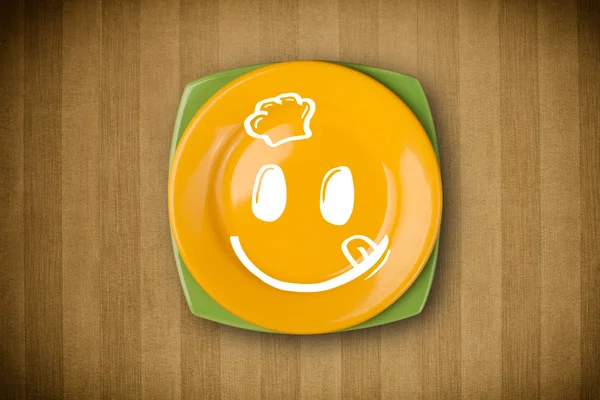 Happy smiley cartoon face on colorful dish plate — Stock Photo, Image