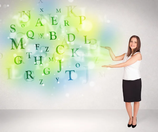 Business women with glowing letter concept — Stock Photo, Image