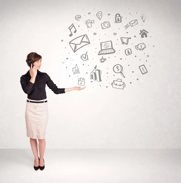 Young business woman presenting hand drawn media icons — Stock Photo, Image