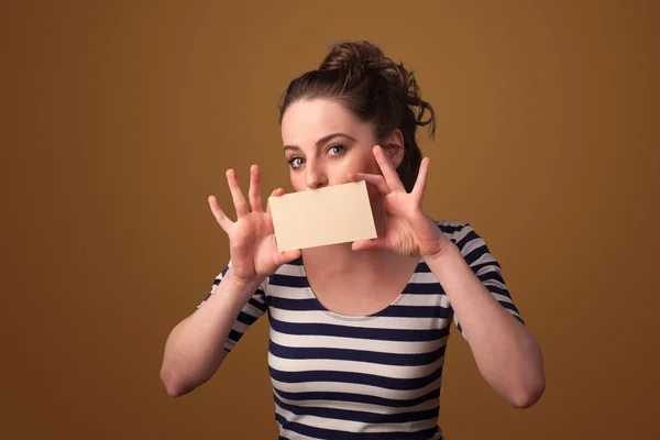 Cute girl holding white card at front of her lips with copy spac — Stock Photo, Image