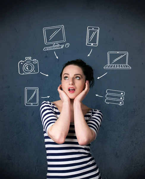 Young woman thinking with drawn gadgets around her head — Stock Photo, Image