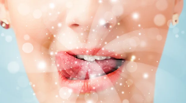 Pretty woman lips blowing abstract white lights — Stock Photo, Image