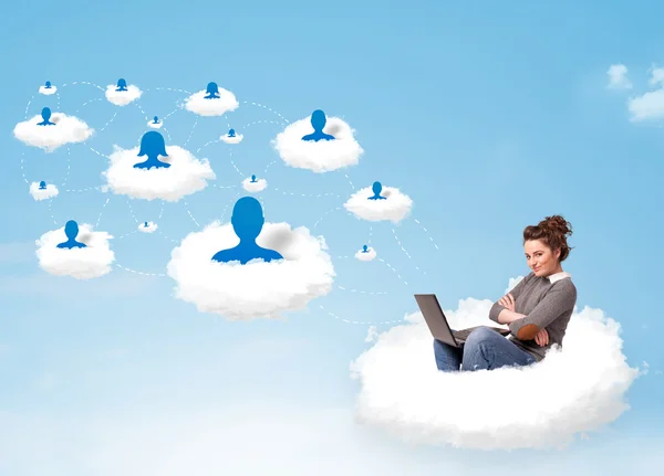 Young woman sitting in cloud with laptop — Stock Photo, Image