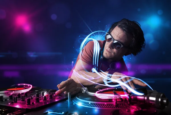 Disc jockey playing music with electro light effects and lights — Stock Photo, Image