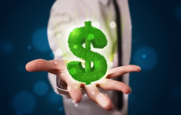 Yeşil parlayan dolar işareti gösteren genç işadamı — Stok fotoğraf