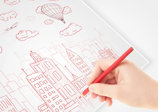 A person drawing sketch of a city with balloons and clouds on a — Stock Photo, Image