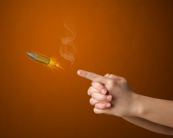 Gun shaped woman hand with bullet — Stock Photo, Image