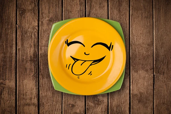 Happy smiley cartoon face on colorful dish plate — Stock Photo, Image