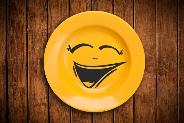 Happy smiley cartoon face on colorful dish plate — Stock Photo, Image