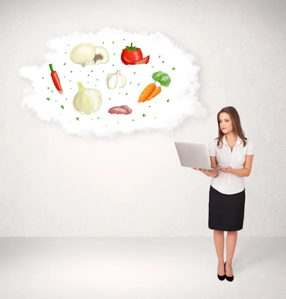 Young girl presenting nutritional cloud with vegetables — Stock Photo, Image