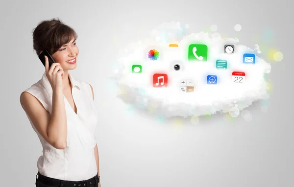 Young woman presenting cloud with colorful app icons and symbols — Stock Photo, Image