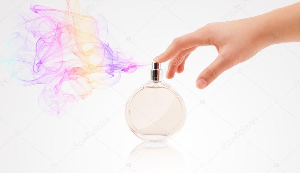Woman hands spraying perfume