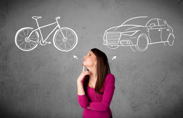 Woman making a choice between bicycle and car — Stock Photo, Image