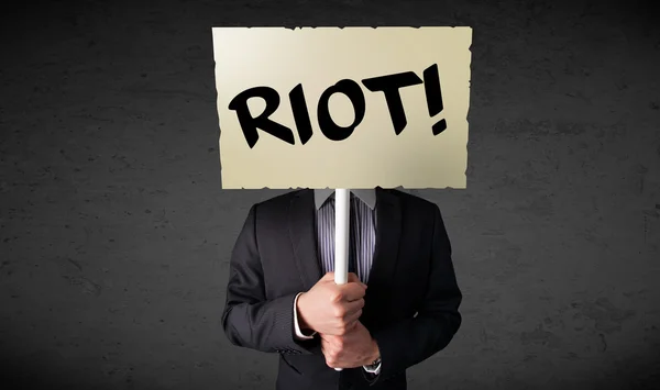 Businessman holding a protest sign — Stock Photo, Image