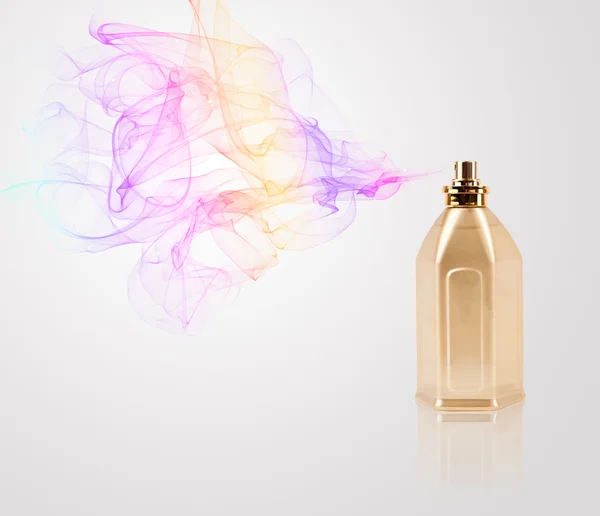 Perfume bottle spraying colored scent — Stock Photo, Image