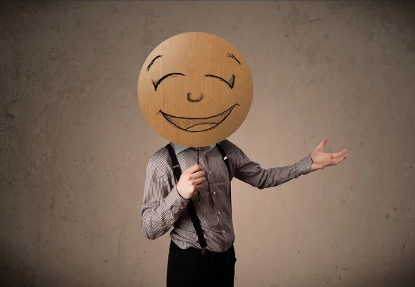 Businessman holding a smiley face board — Stock Photo, Image