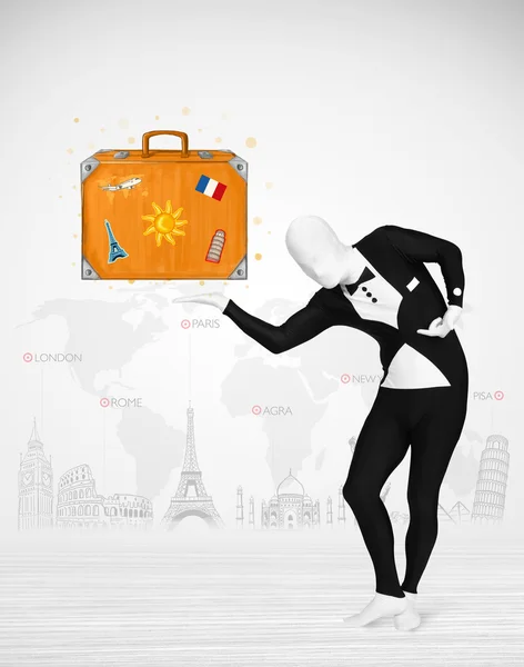 Man in full body suit presenting vacation suitcase — Stock Photo, Image