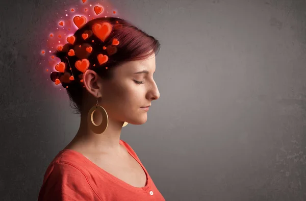 Young person thinking about love with red hearts — Stock Photo, Image