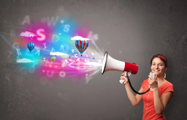 Girl shouting into megaphone and abstract text and balloons come — Stock Photo, Image