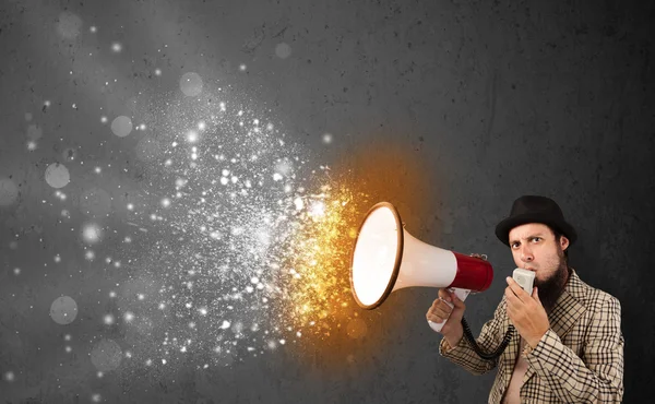 Guy shouting into megaphone and glowing energy particles explode — Stock Photo, Image