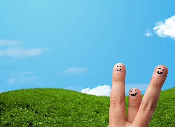 Cheerful finger smileys with landscape scenery at the background — Stock Photo, Image