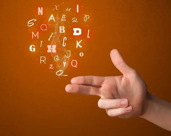 Letters coming out of gun shaped hands — Stock Photo, Image