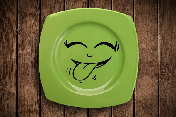 Happy smiley cartoon face on colorful dish plate — Stock Photo, Image