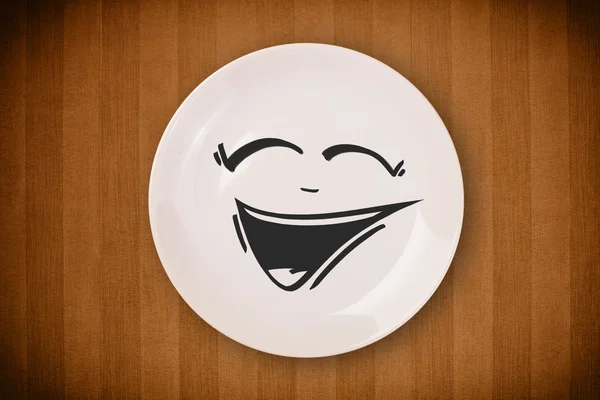 Happy smiley cartoon face on colorful dish plate — Stock Photo, Image