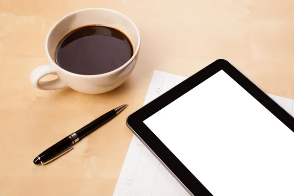 Tablet pc with empty space and a cup of coffee on a desk — Stock Photo, Image