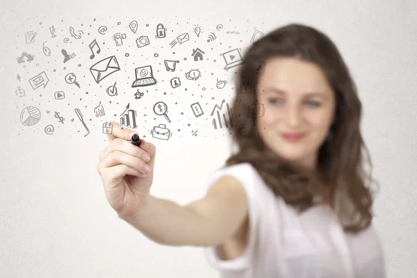 Young woman drawing and sketching icons and symbols — Stock Photo, Image