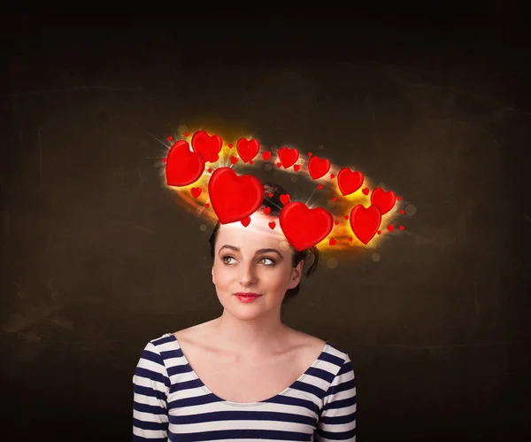 Menina adolescente com ilustrações do coração circulando em torno de sua cabeça — Fotografia de Stock