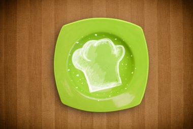 El çizimi beyaz şef sembollü renkli bir tabak.