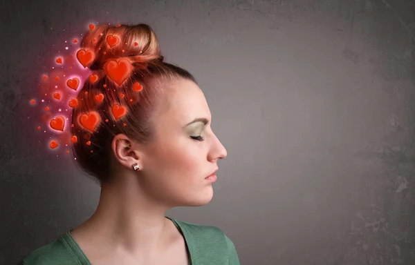 Young person thinking about love with red hearts — Stock Photo, Image