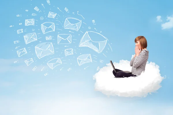 Young woman sitting in cloud with laptop — Stock Photo, Image