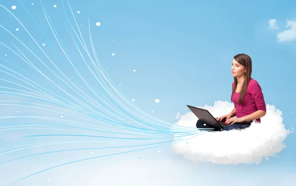 Young woman sitting in cloud with laptop — Stock Photo, Image