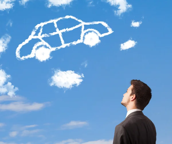 Handsome young man looking at car cloud on a blue sky — Stock Photo, Image