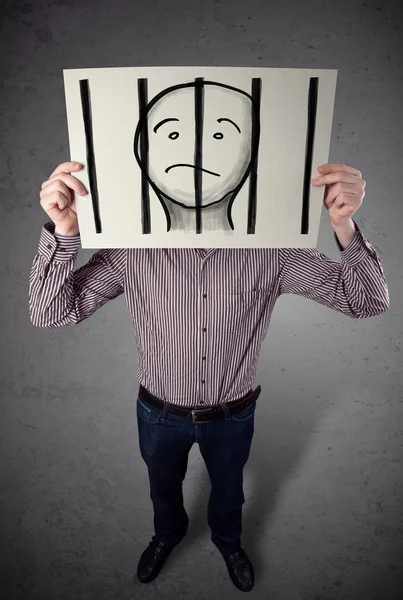 Businessman holding a paper with a prisoner behind the bars on i — Stock Photo, Image