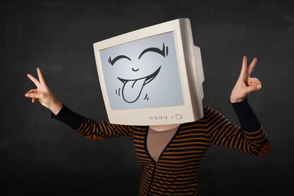 Young girl wearing a monitor with a funny face — Stock Photo, Image