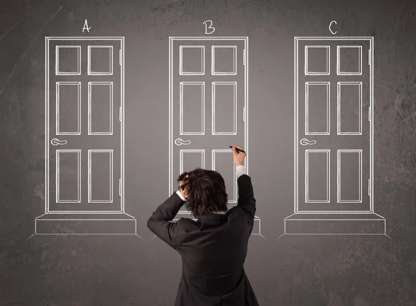 Businessman choosing the right door — Stock Photo, Image