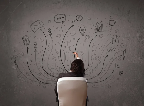 Businessman in front of a chalkboard deciding with arrows and si — Stock Photo, Image