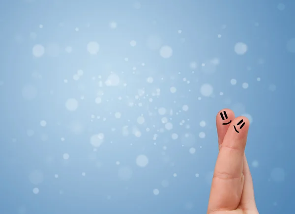 Happy finger smileys with empty blue bokeh background — Stock Photo, Image