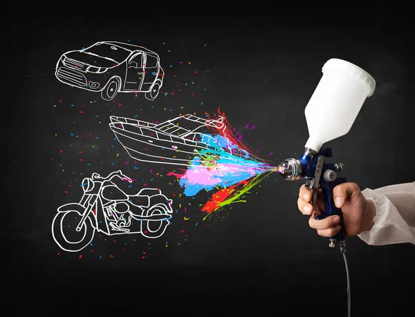 Man with airbrush spray paint with car, boat and motorcycle draw — Stock Photo, Image