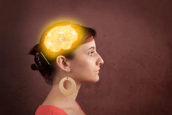 Young girl thinking with glowing brain illustration — Stock Photo, Image